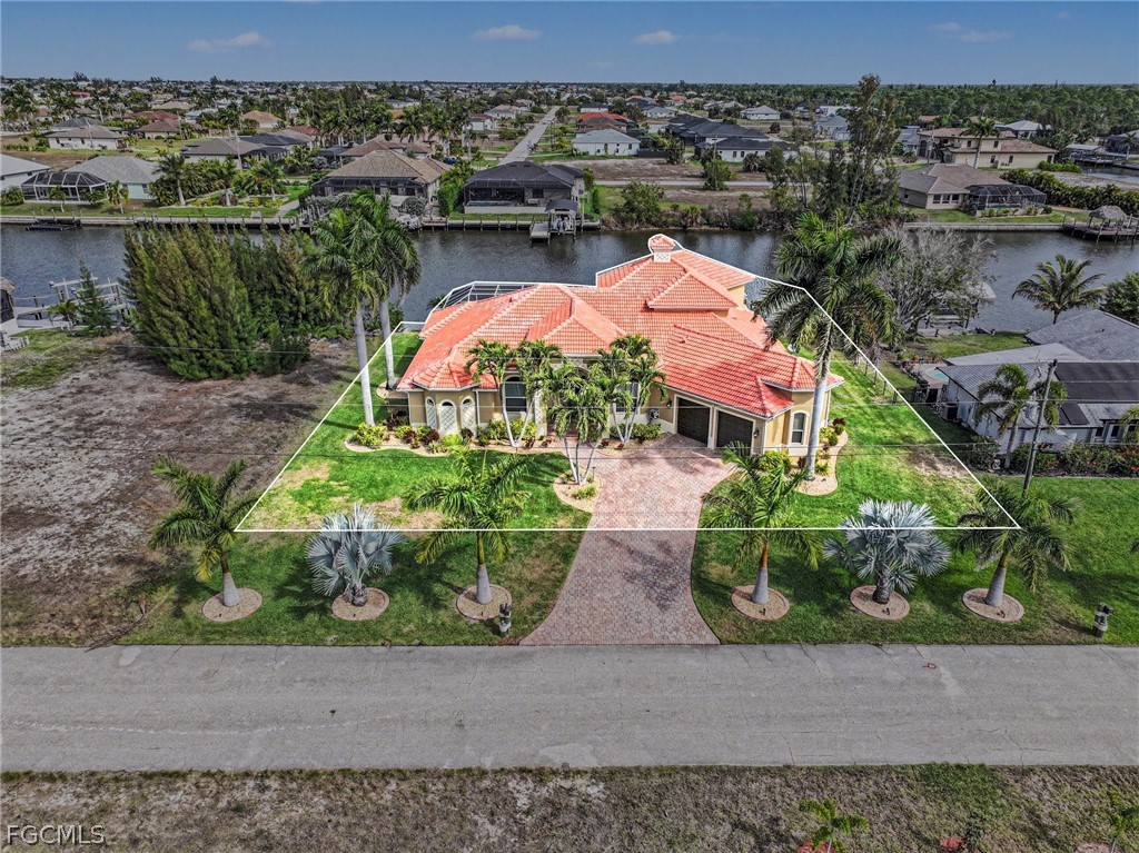 4113 Northwest 26th Street Cape Coral, FL 33993 - Photo 35 of 37 an aerial view of a house with a garden and lake view