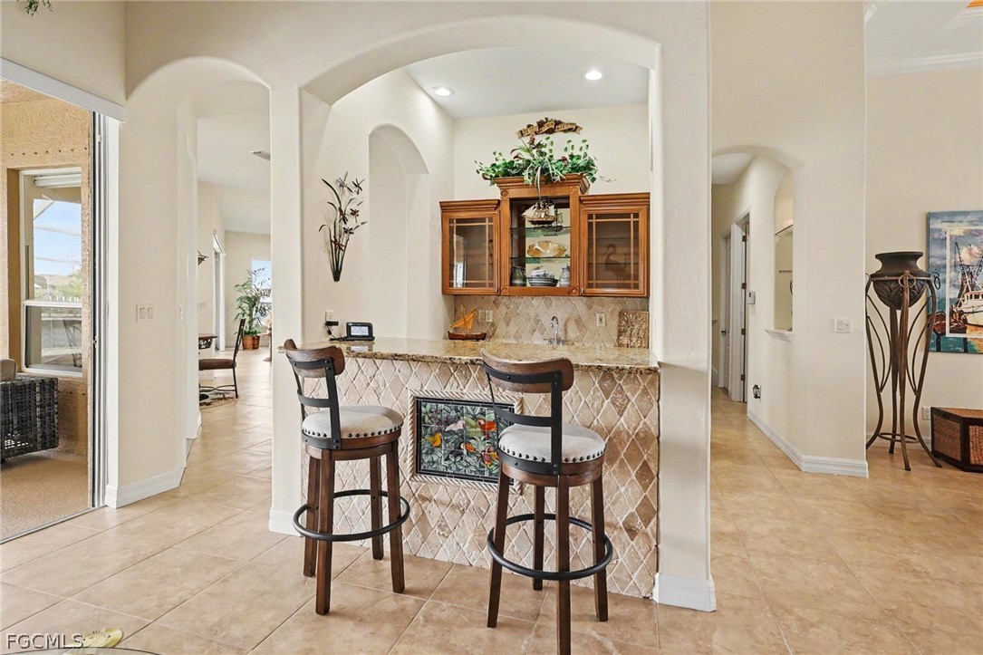 4113 Northwest 26th Street Cape Coral, FL 33993 - Photo 7 of 37 a view of a dining room with furniture and a chandelier