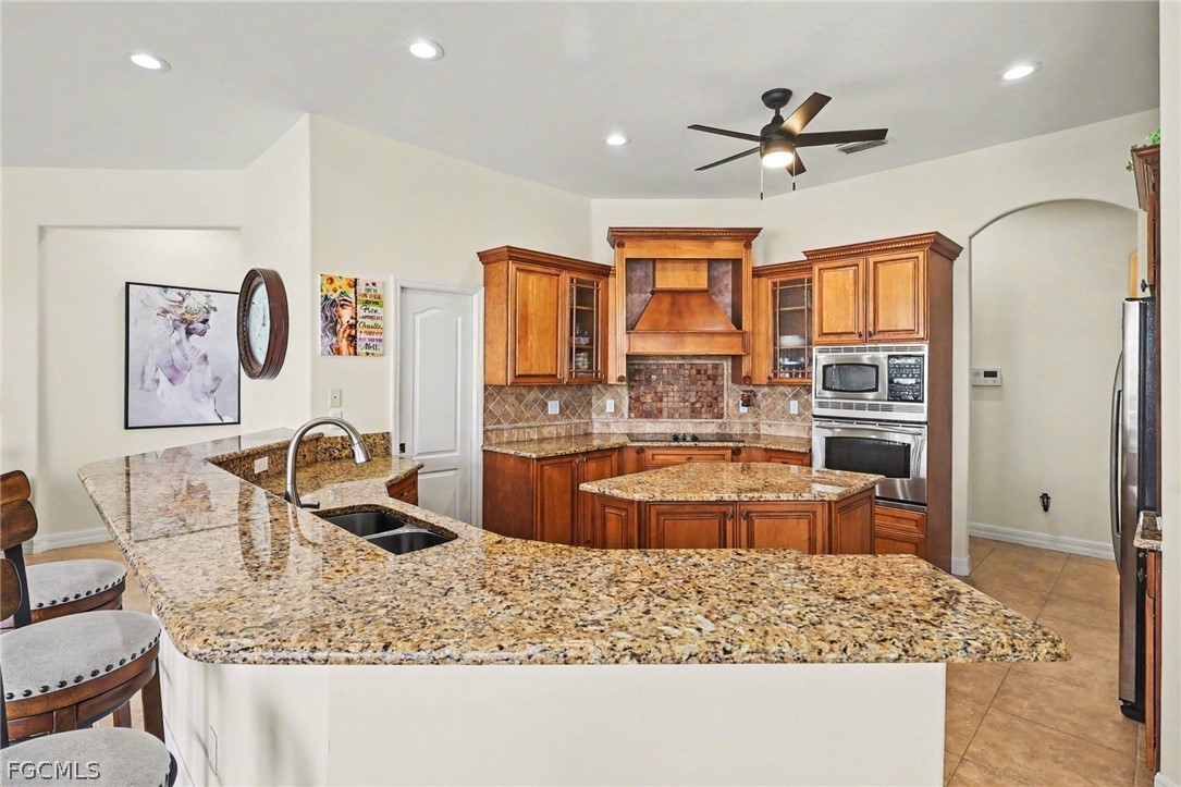 4113 Northwest 26th Street Cape Coral, FL 33993 - Photo 10 of 37 a kitchen with stainless steel appliances granite countertop a sink stove and refrigerator