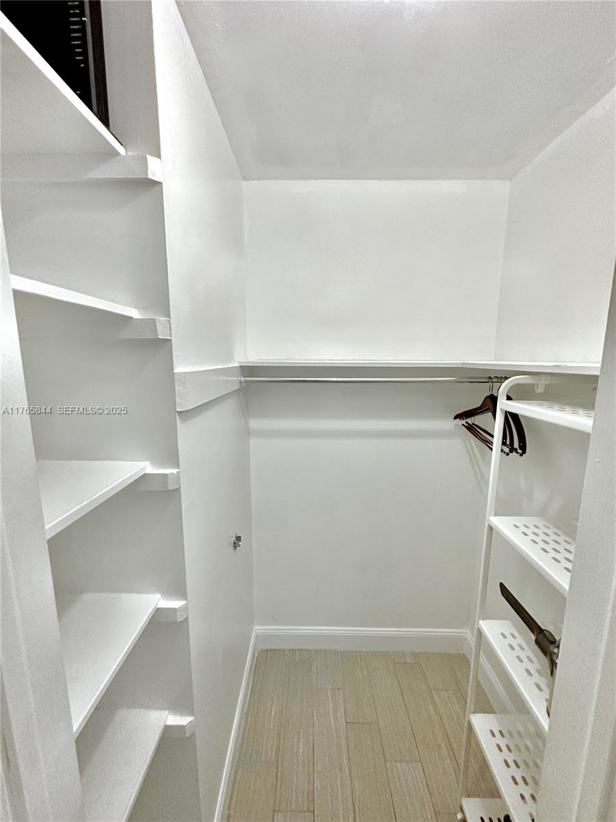 2201 Northeast 66th Street, Unit 1301 Fort Lauderdale, FL 33308 - Photo 11 of 23 a view of walk in closet with empty racks