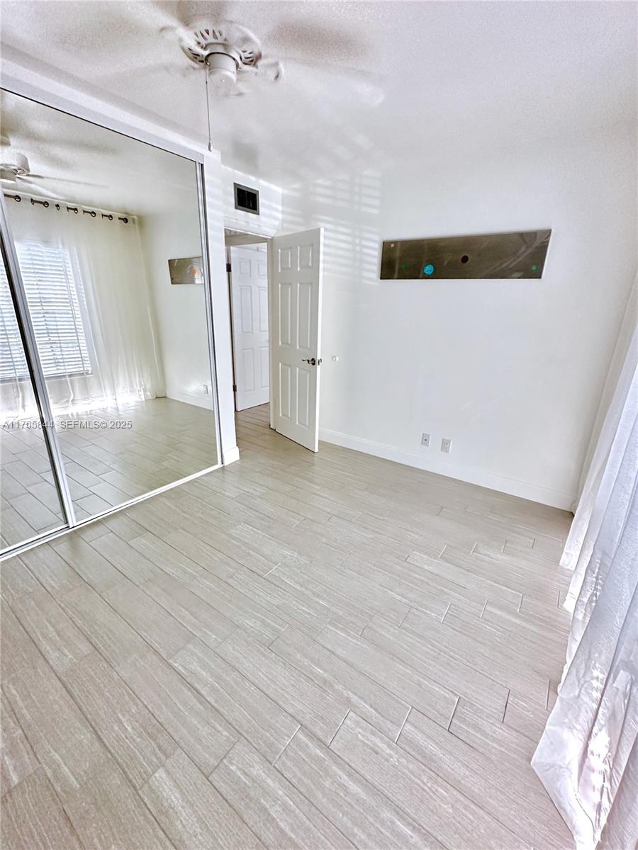 2201 Northeast 66th Street, Unit 1301 Fort Lauderdale, FL 33308 - Photo 16 of 23 a view of empty room with wooden floor
