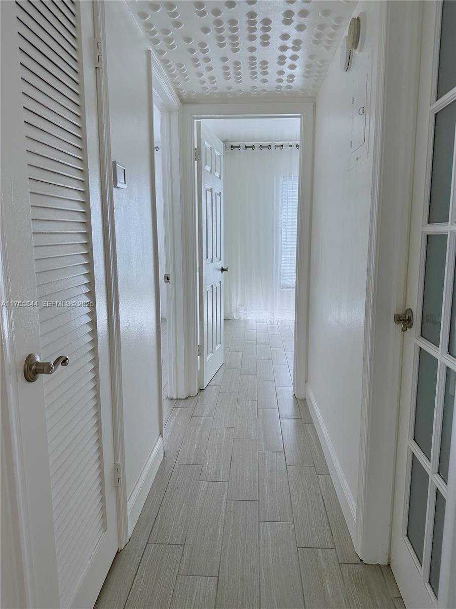 2201 Northeast 66th Street, Unit 1301 Fort Lauderdale, FL 33308 - Photo 5 of 23 a view of a hallway with wooden floor