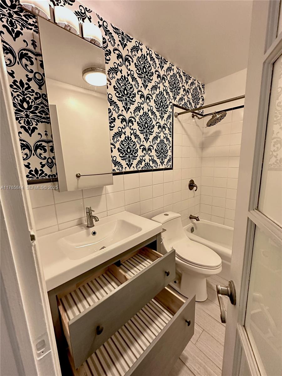 2201 Northeast 66th Street, Unit 1301 Fort Lauderdale, FL 33308 - Photo 6 of 23 a bathroom with a sink and a mirror