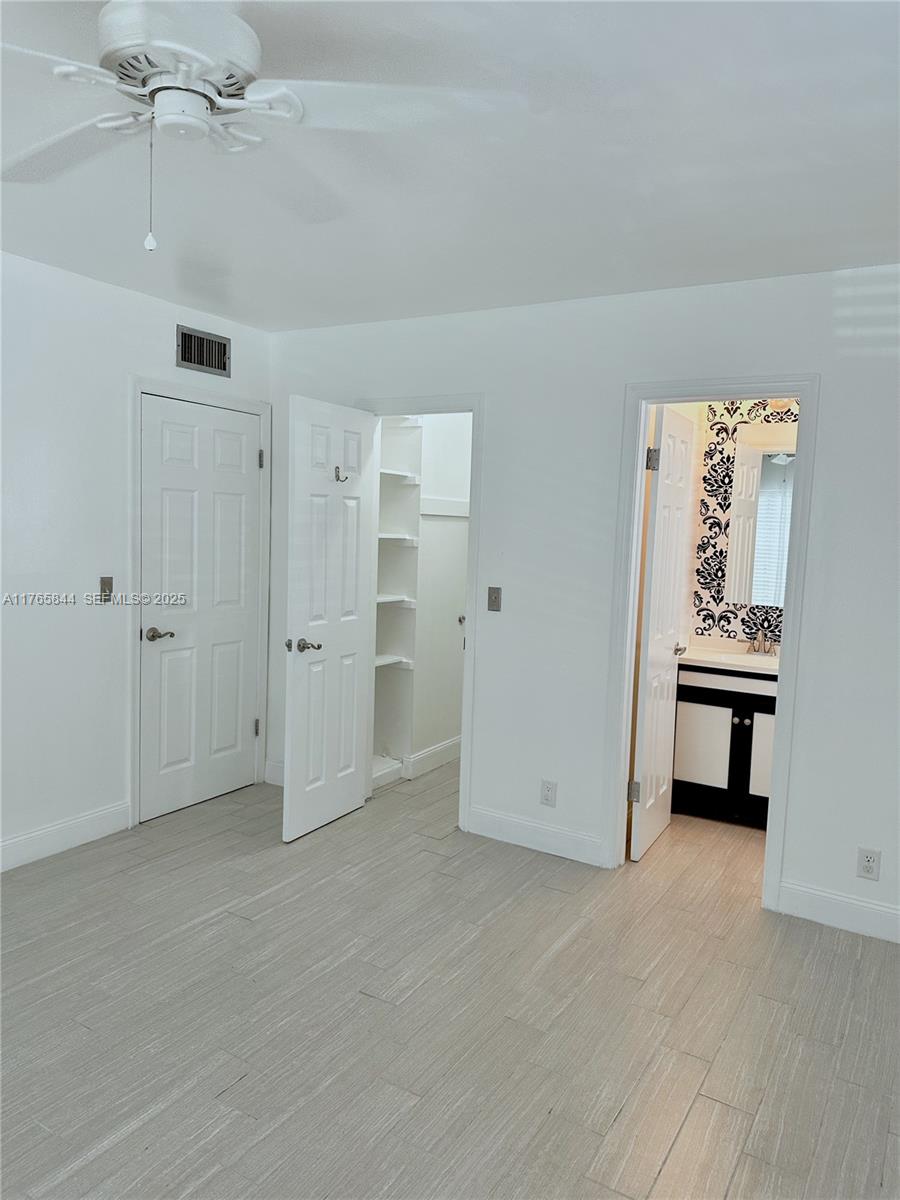 2201 Northeast 66th Street, Unit 1301 Fort Lauderdale, FL 33308 - Photo 9 of 23 an empty room with windows and closet
