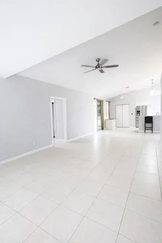 a view of a big yard with plants and large trees