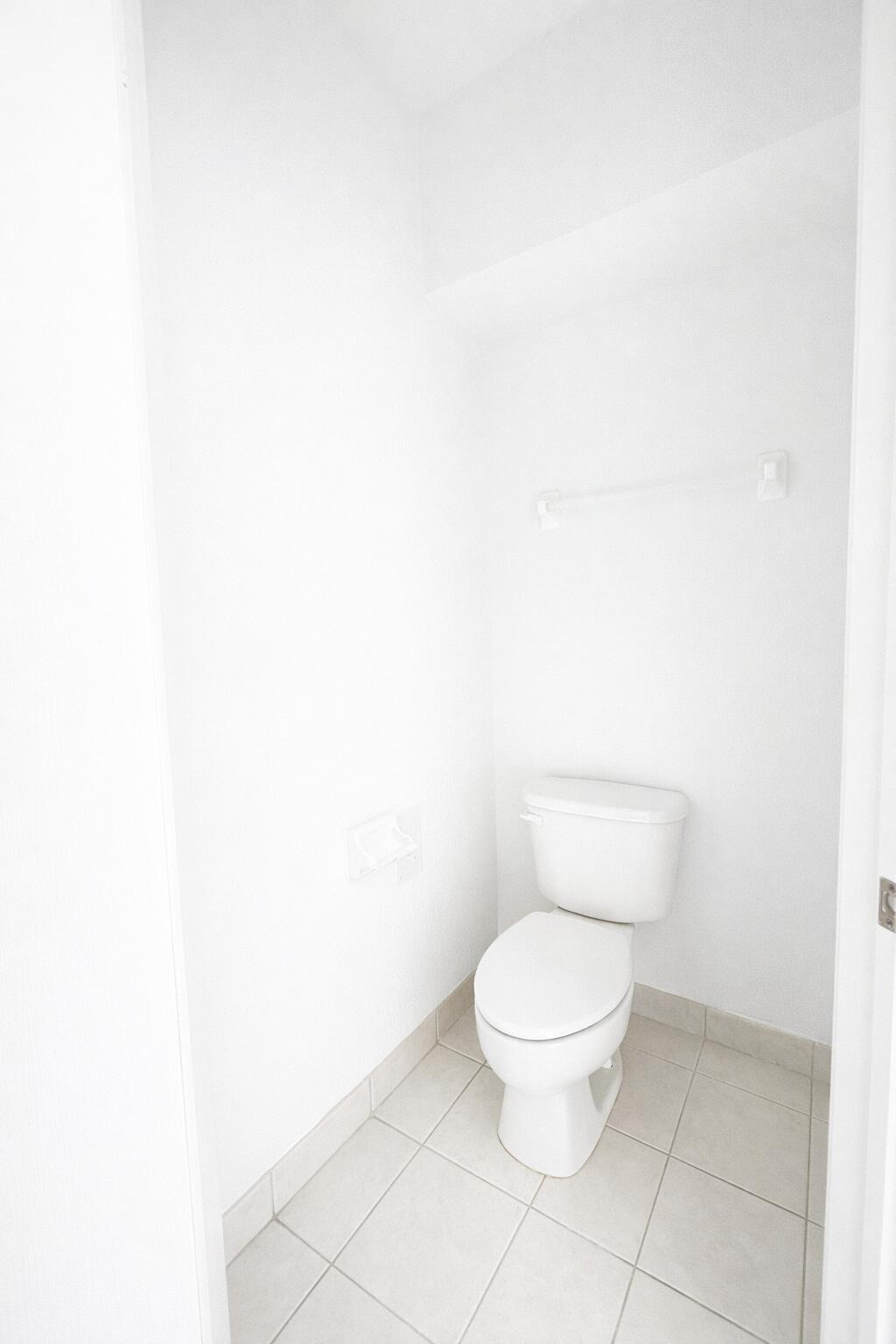 13218 86th Road North West Palm Beach, FL 33412 - Photo 22 of 40 a white toilet sitting next to a white cabinet