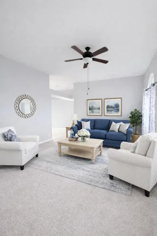 a living room with furniture and a chandelier