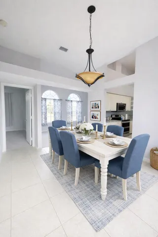 a white toilet sitting next to a white cabinet