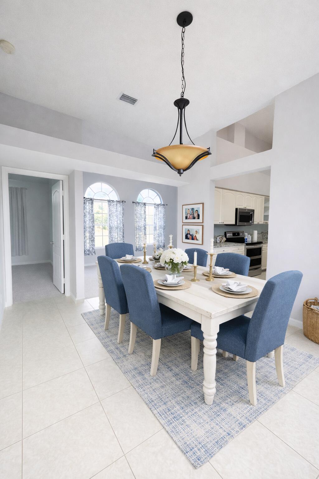 13218 86th Road North West Palm Beach, FL 33412 - Photo 7 of 40 a view of a dining room and livingroom with furniture wooden floor a rug a painting and a chandelier
