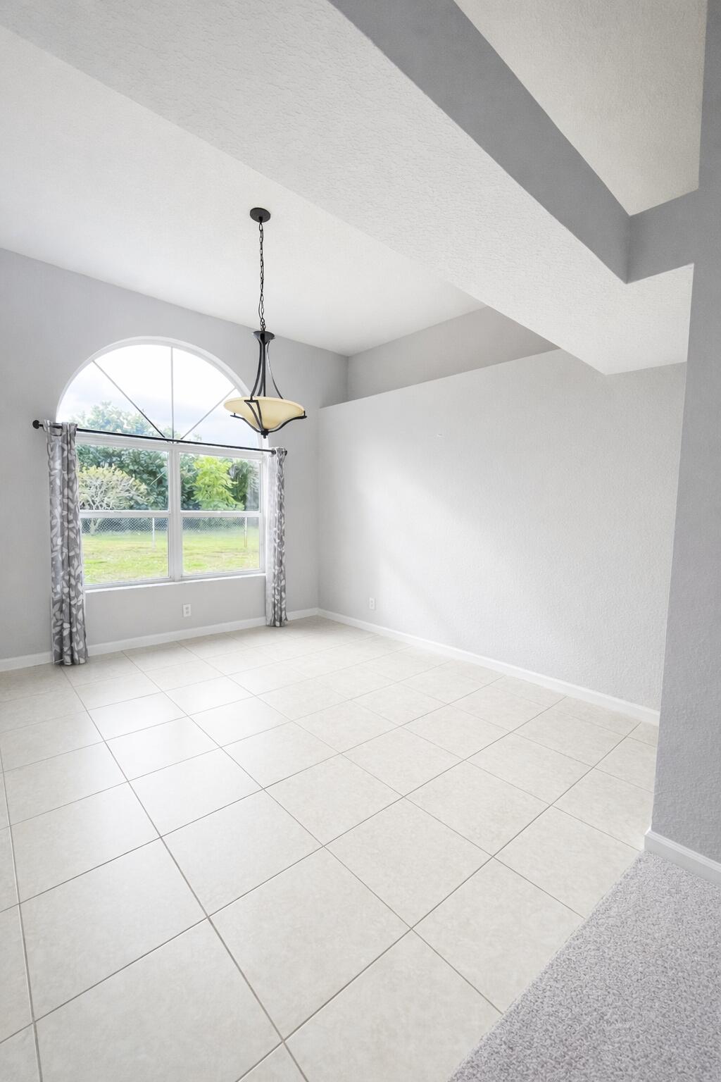 13218 86th Road North West Palm Beach, FL 33412 - Photo 8 of 40 an empty room with a ceiling fan and window