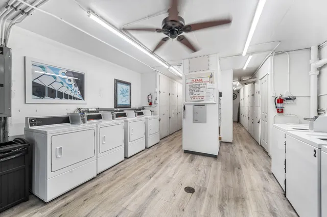 a kitchen with cabinets and wooden floor