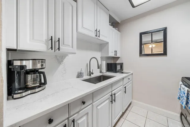 a kitchen with stainless steel appliances a sink and cabinets