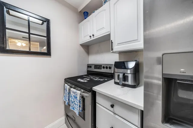 a kitchen with granite countertop a stove and a sink