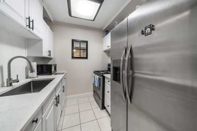 a kitchen with a refrigerator sink and stove