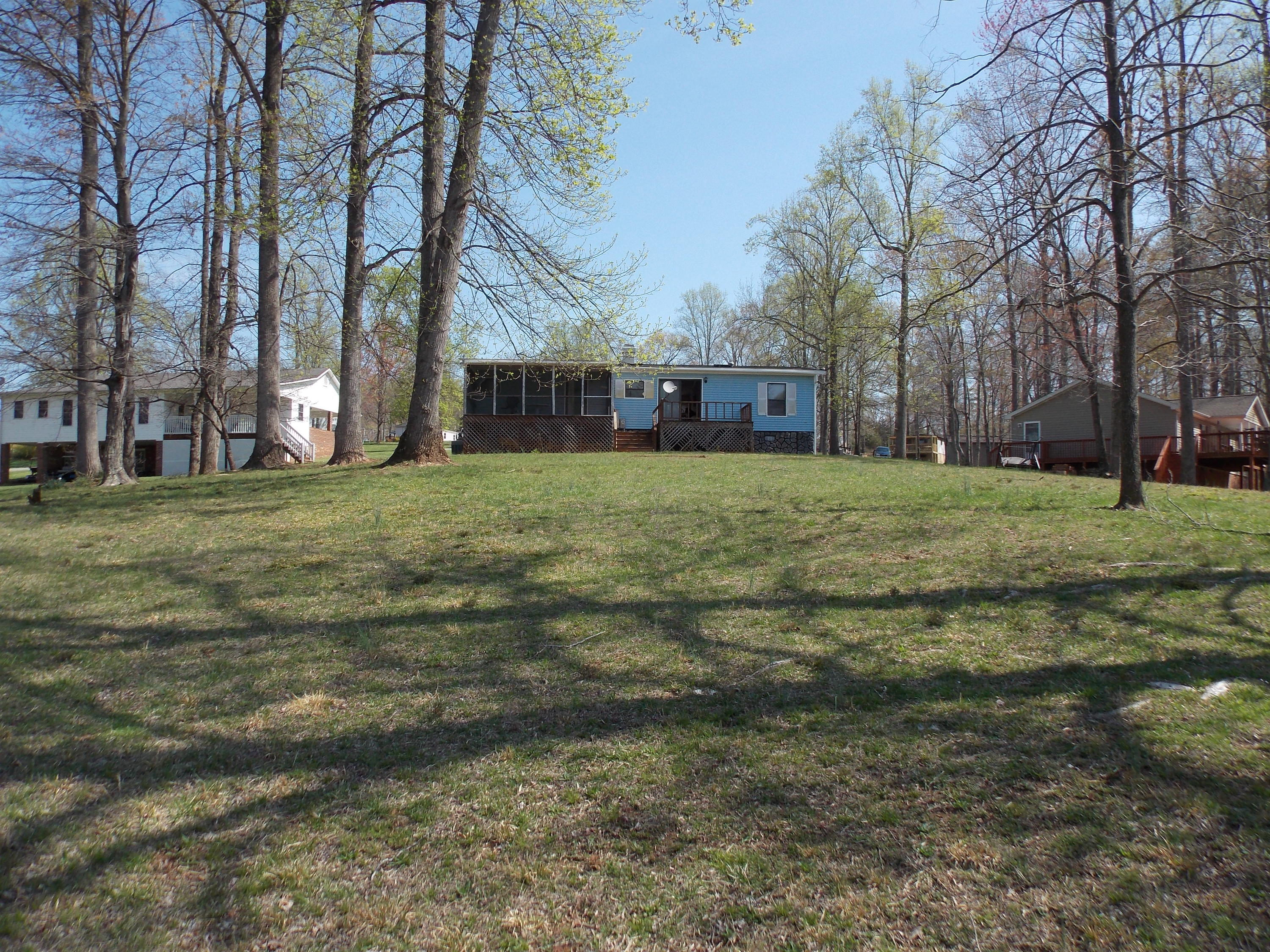 356 Cool Branch Road Penhook, VA 24137 - Photo 14 of 40 a tall house with a big yard and large trees