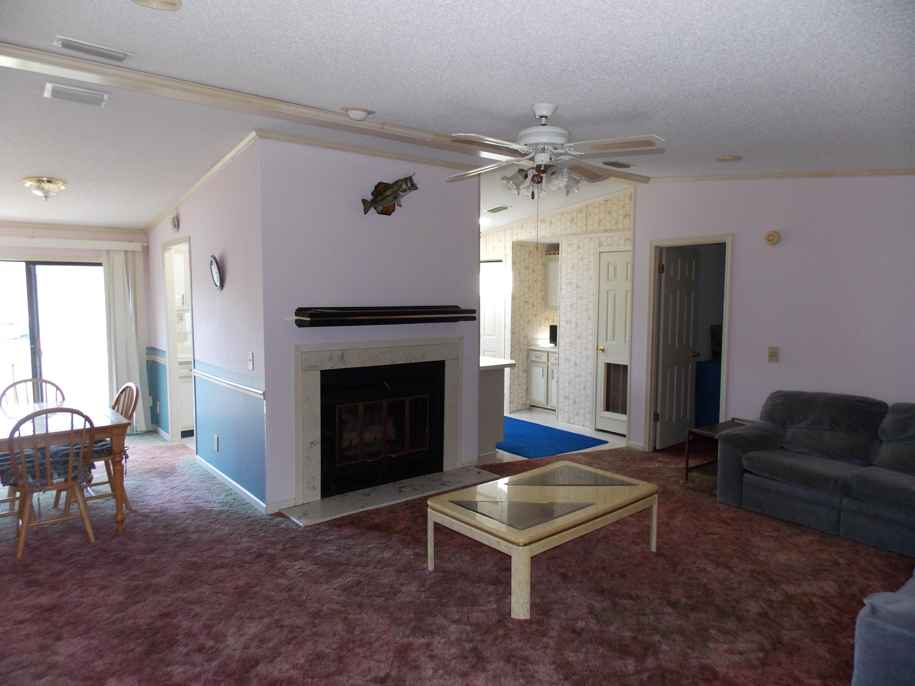 356 Cool Branch Road Penhook, VA 24137 - Photo 25 of 40 a living room with furniture a table and a fireplace