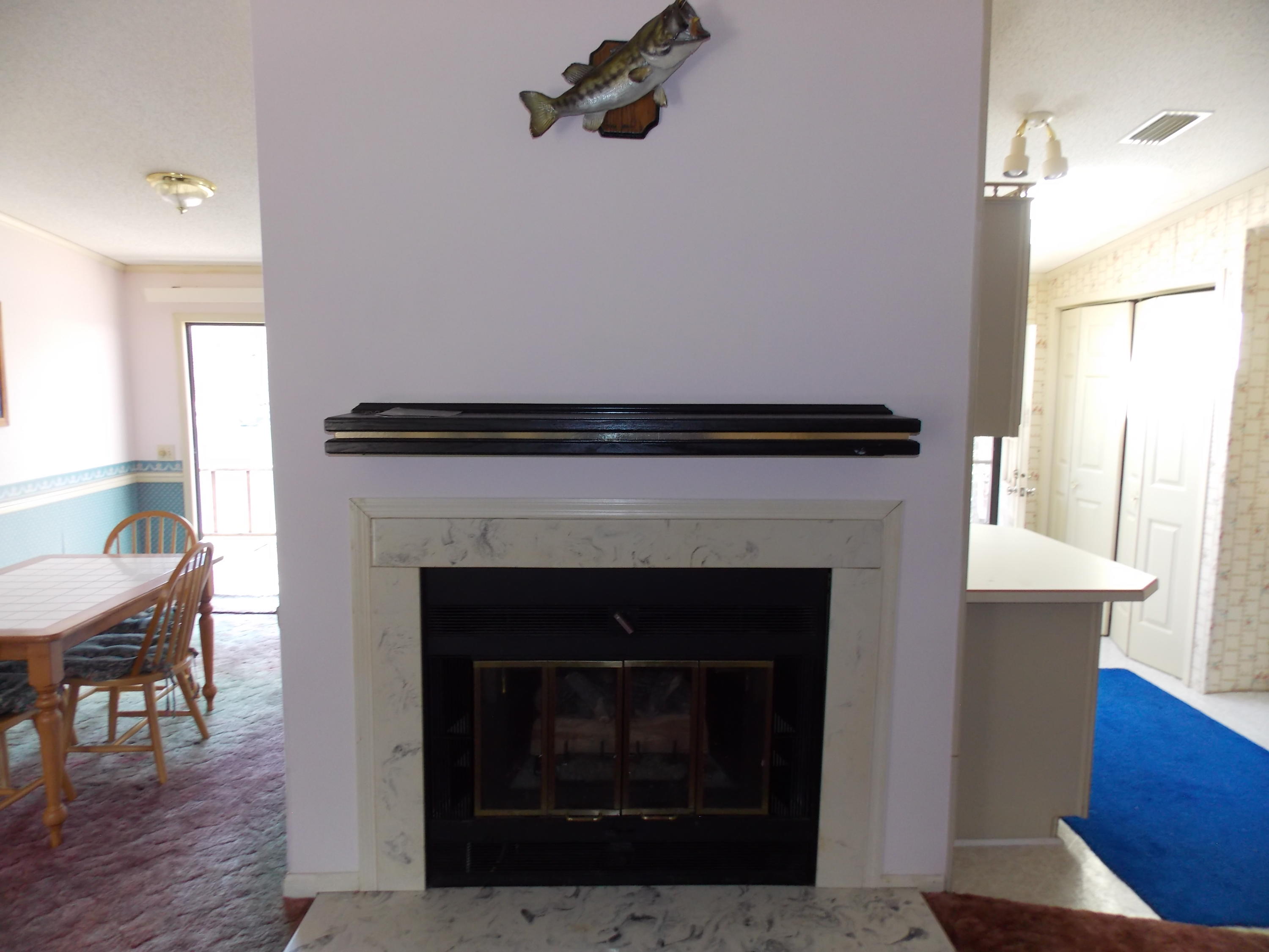 356 Cool Branch Road Penhook, VA 24137 - Photo 28 of 40 a living room with a fireplace and a table