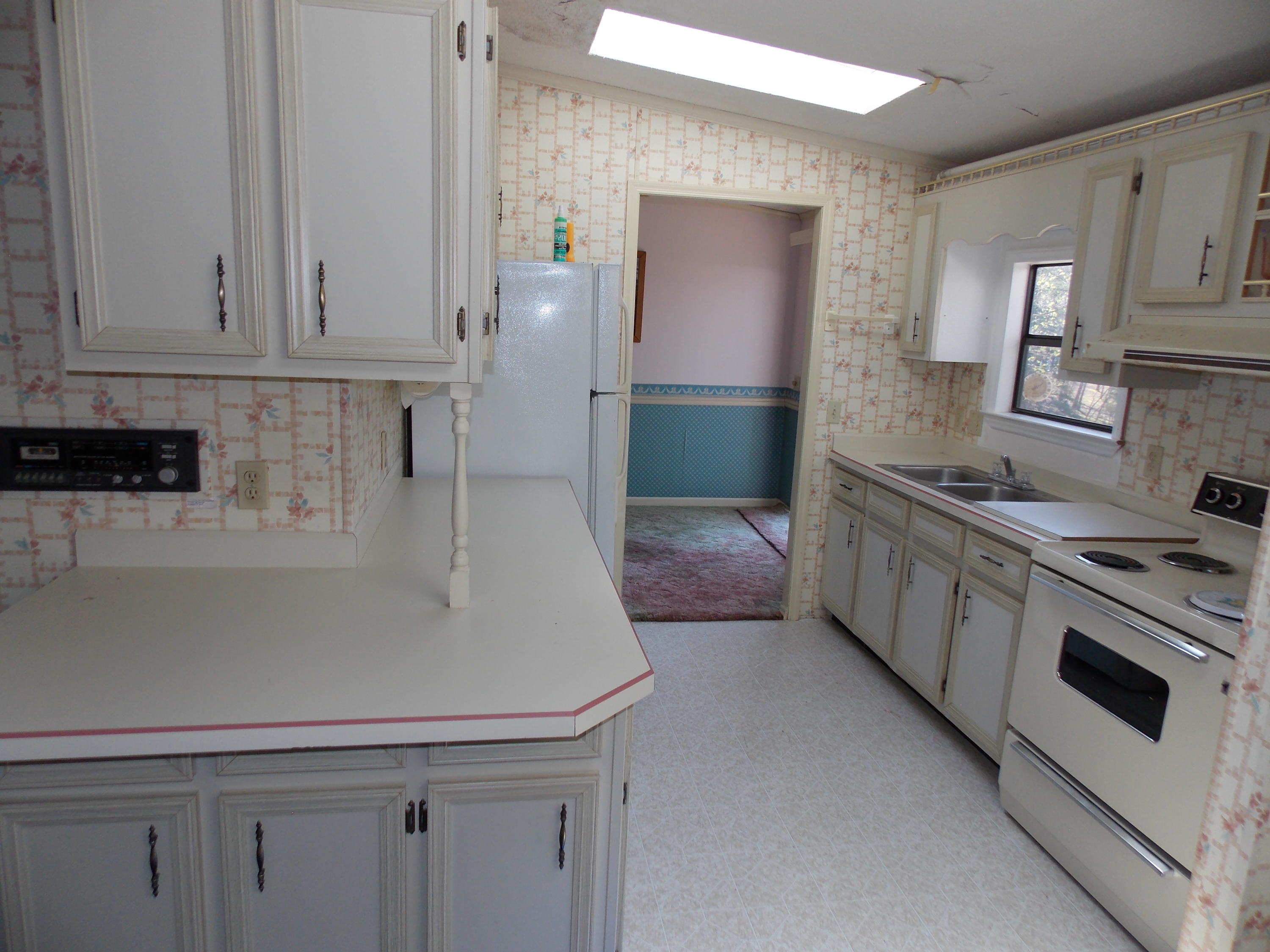 356 Cool Branch Road Penhook, VA 24137 - Photo 30 of 40 a kitchen with stainless steel appliances white cabinets and a refrigerator