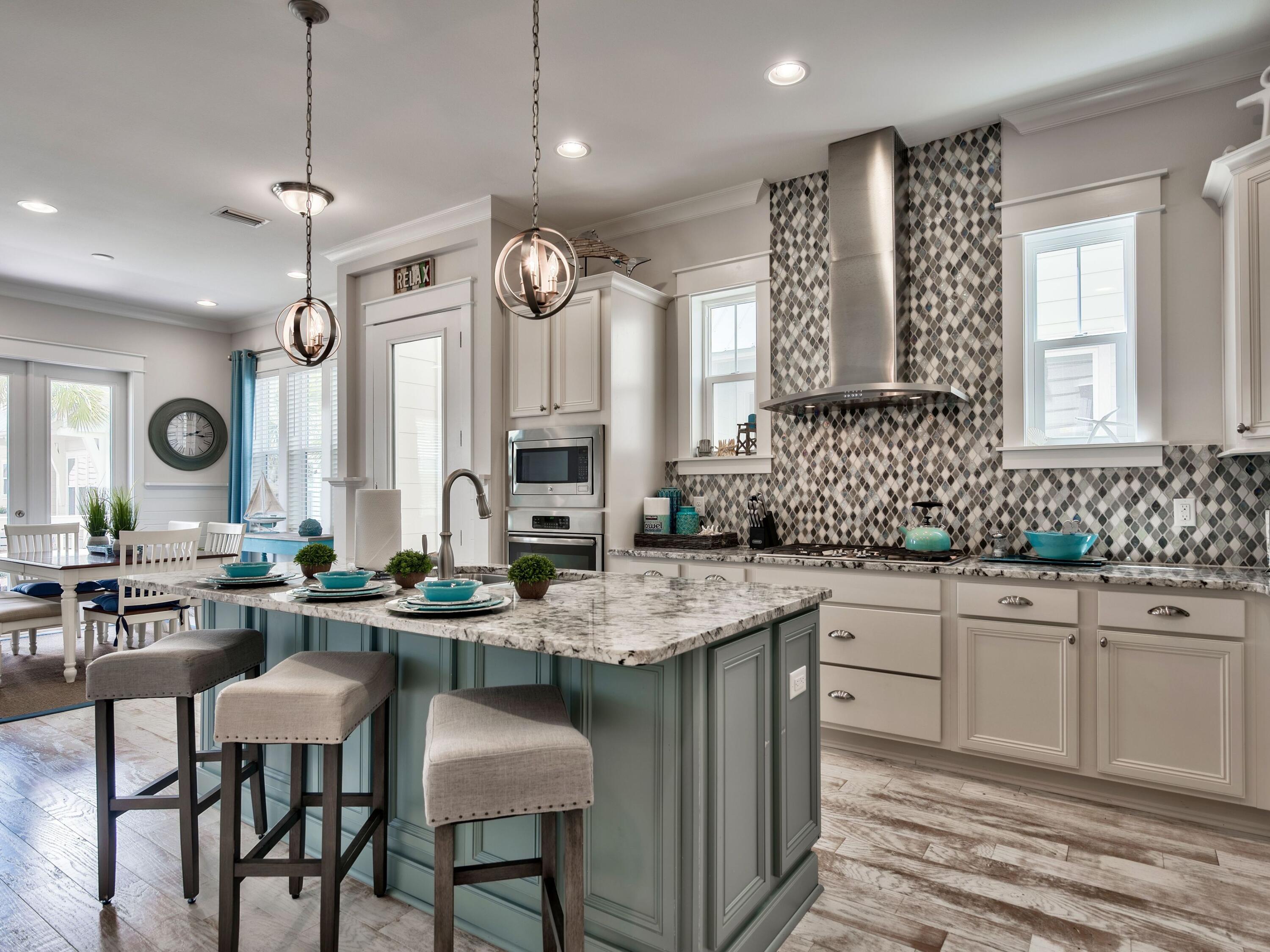 a kitchen with center island table and chairs in it