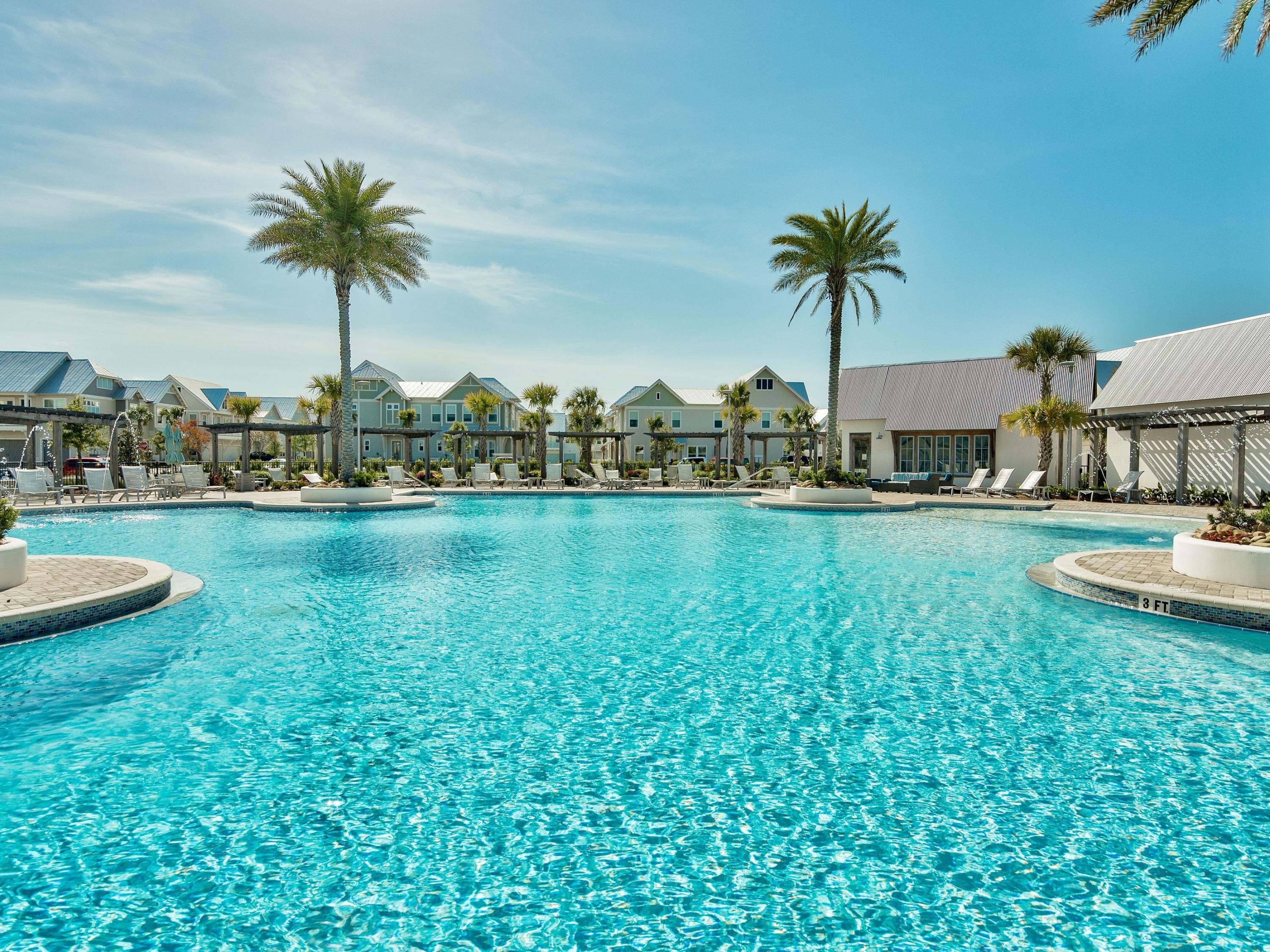 25 York Ln Inlet Beach, Unit B Inlet Beach, FL 32461 - Photo 13 of 14 a view of a swimming pool and a table and chairs in patio