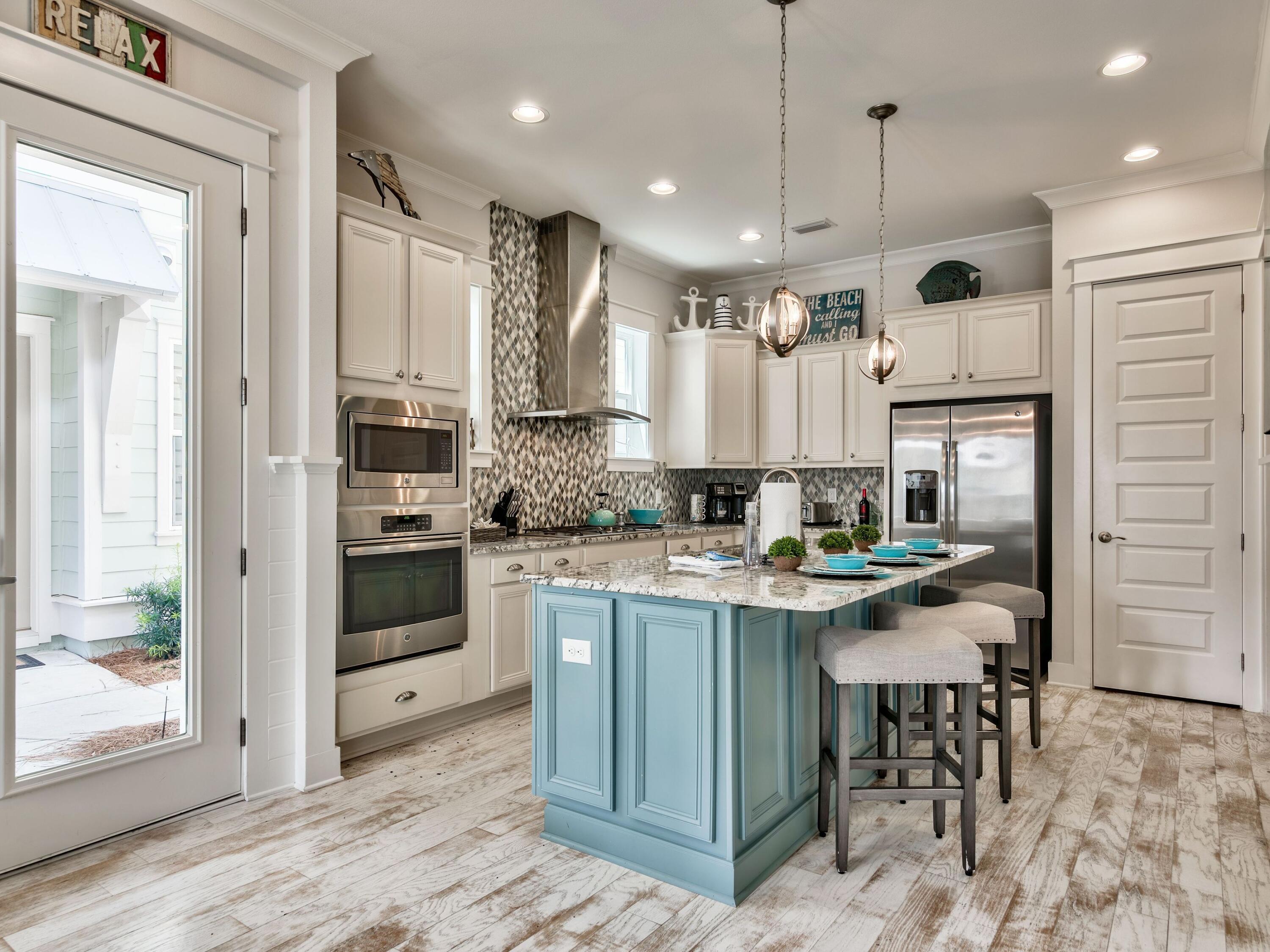25 York Ln Inlet Beach, Unit B Inlet Beach, FL 32461 - Photo 2 of 14 a kitchen with stainless steel appliances kitchen island granite countertop a stove and a refrigerator