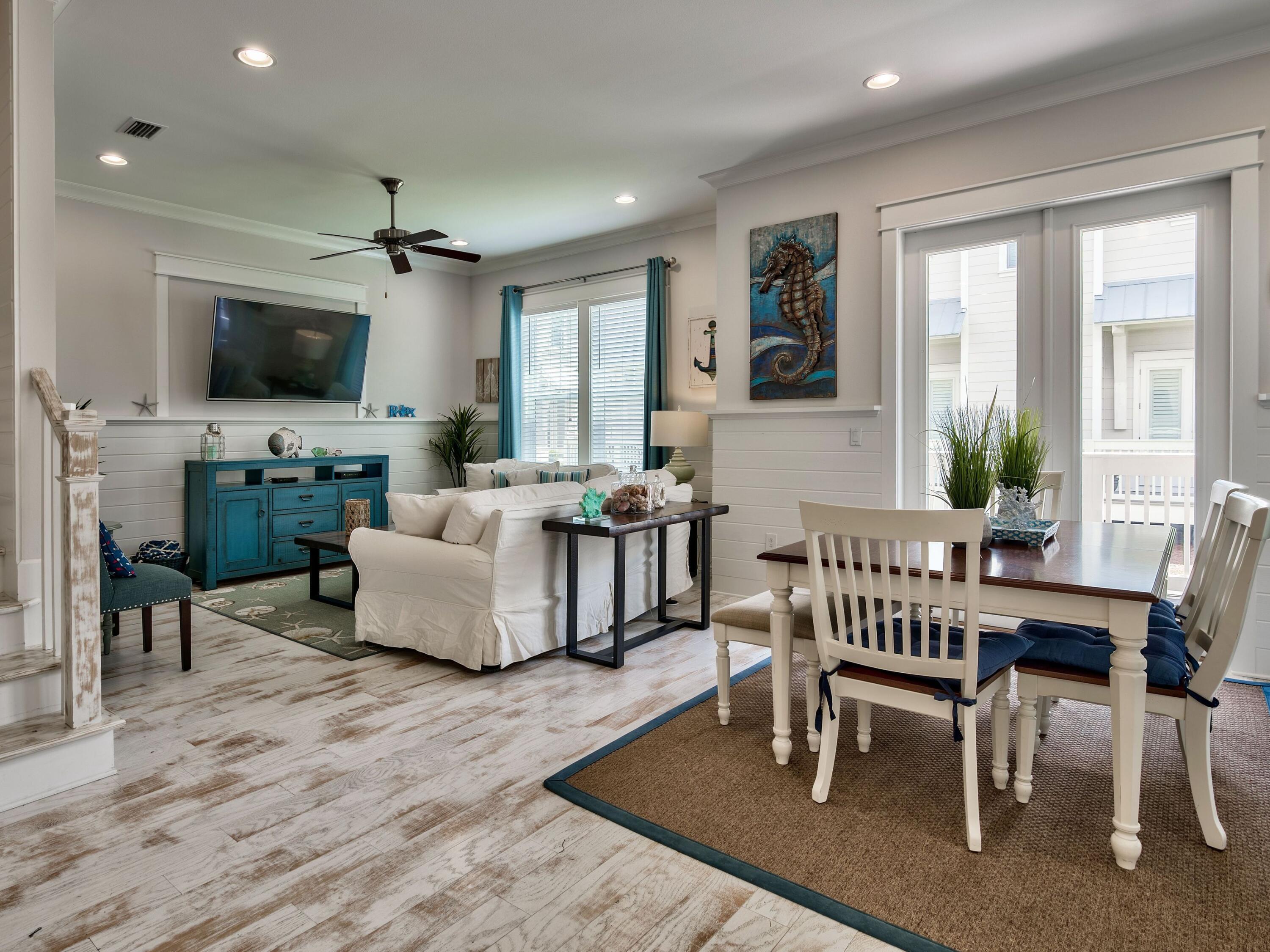 25 York Ln Inlet Beach, Unit B Inlet Beach, FL 32461 - Photo 4 of 14 a living room with furniture a flat screen tv and a table