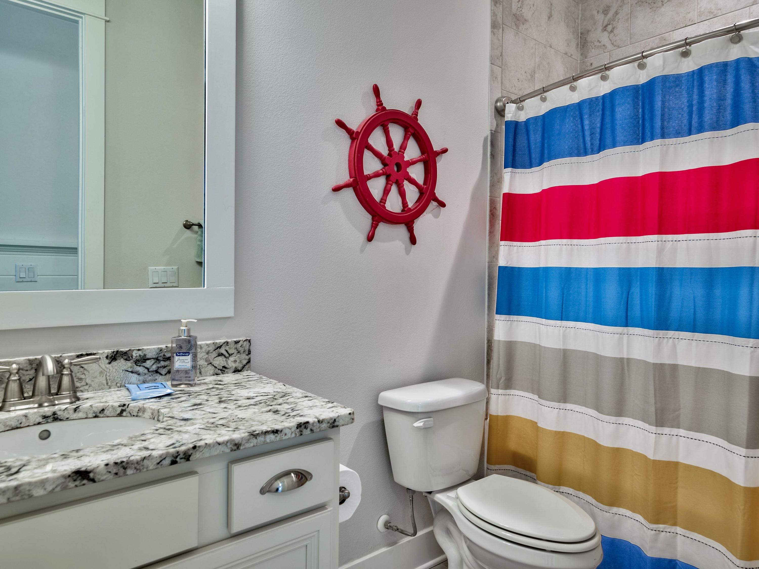 25 York Ln Inlet Beach, Unit B Inlet Beach, FL 32461 - Photo 9 of 14 a bathroom with a sink a toilet and a shower curtain