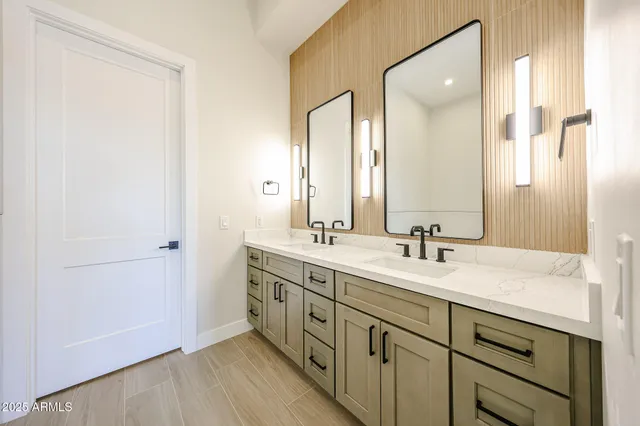 a bathroom with a double vanity sink and mirror