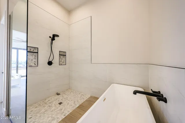 a bathroom with a bathtub and shower