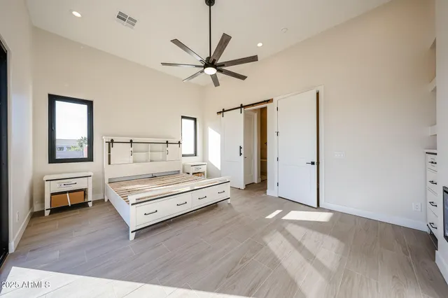 a bedroom with a bed and a chandelier