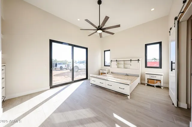 a living room with a bed furniture and a large window
