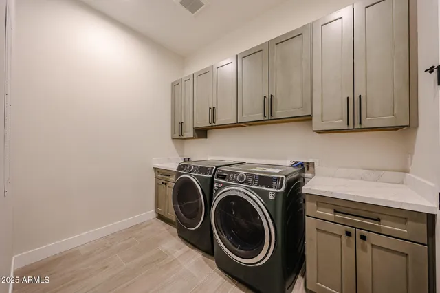 a view of a storage and utility room with washer and dryer