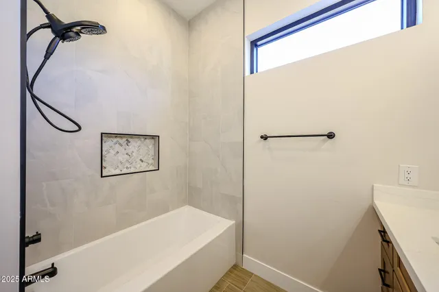 a bathroom with a bathtub and a shower