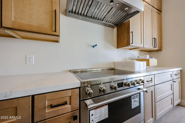 a stove top oven sitting inside of a kitchen