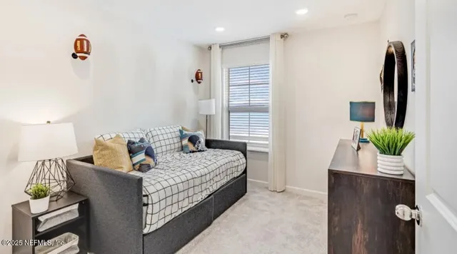 a living room with furniture kitchen view and a large window
