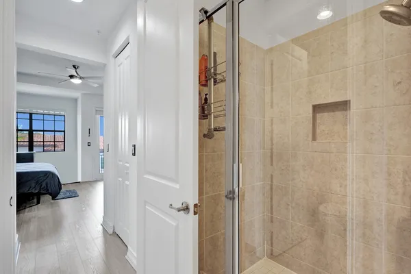 a view of a room that has a glass door shower and closet