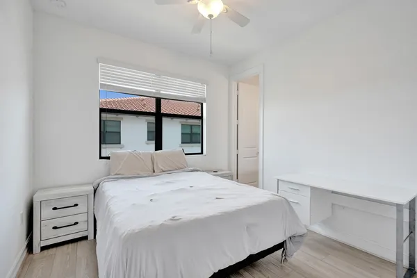 a bedroom with a bed and a chandelier