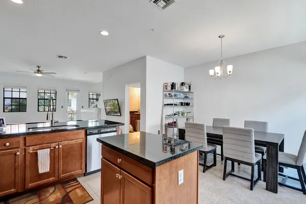 a kitchen with granite countertop a sink stove and cabinets