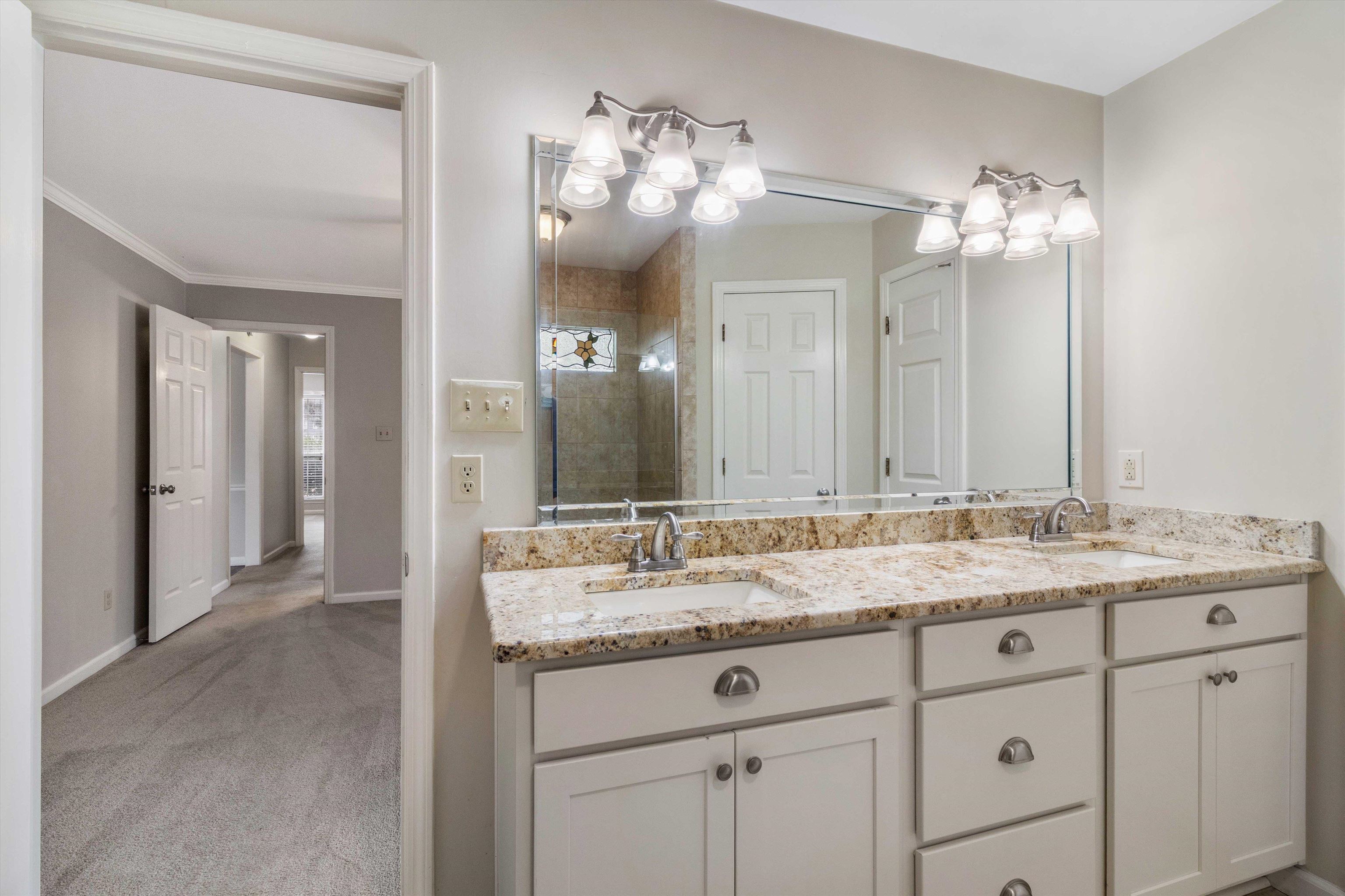 486 Harts Way Drive Collierville, TN 38017 - Photo 20 of 39 a bathroom with a granite countertop double vanity sink and a mirror