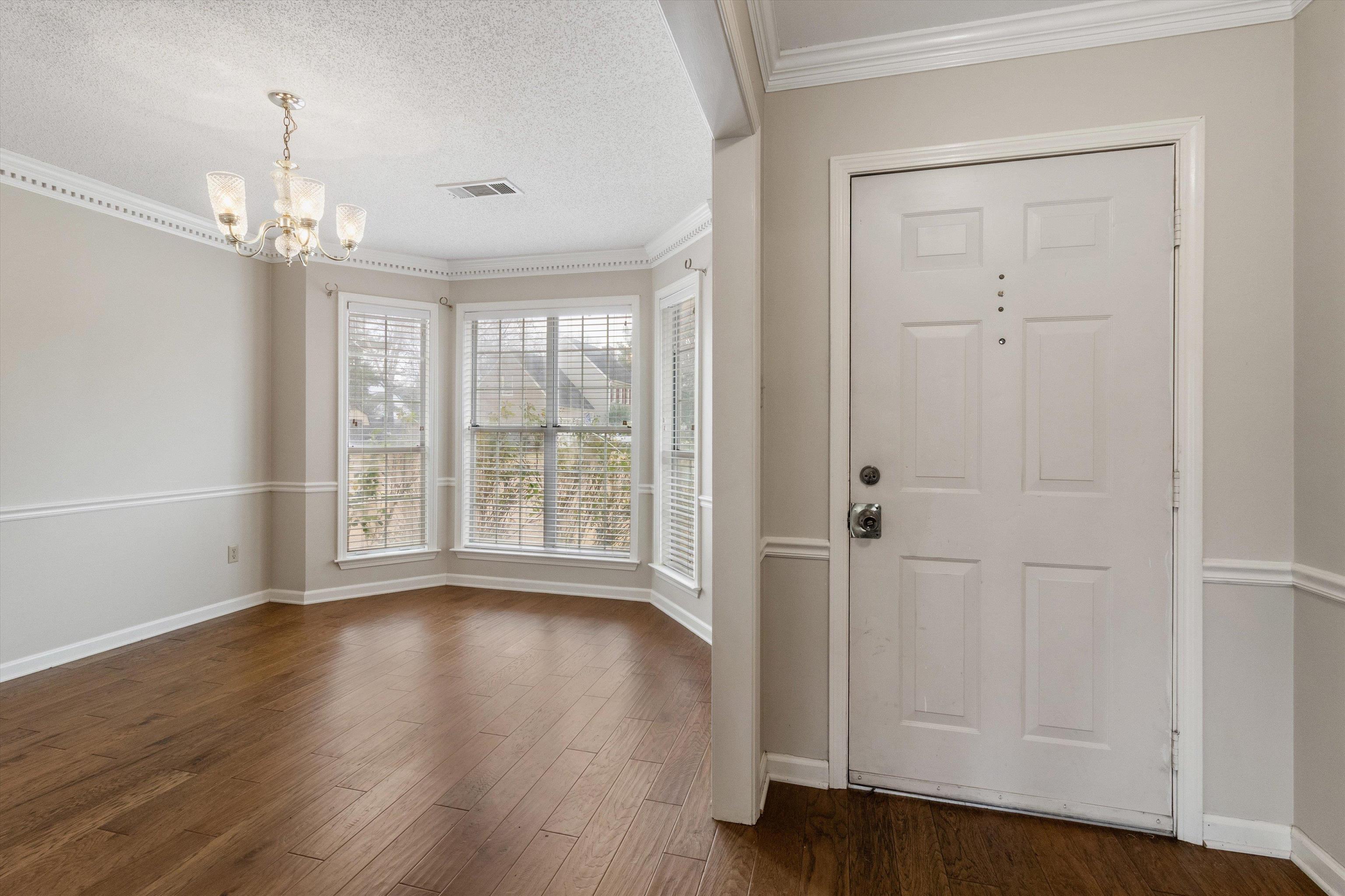 486 Harts Way Drive Collierville, TN 38017 - Photo 5 of 39 a view of an empty room with wooden floor and a window