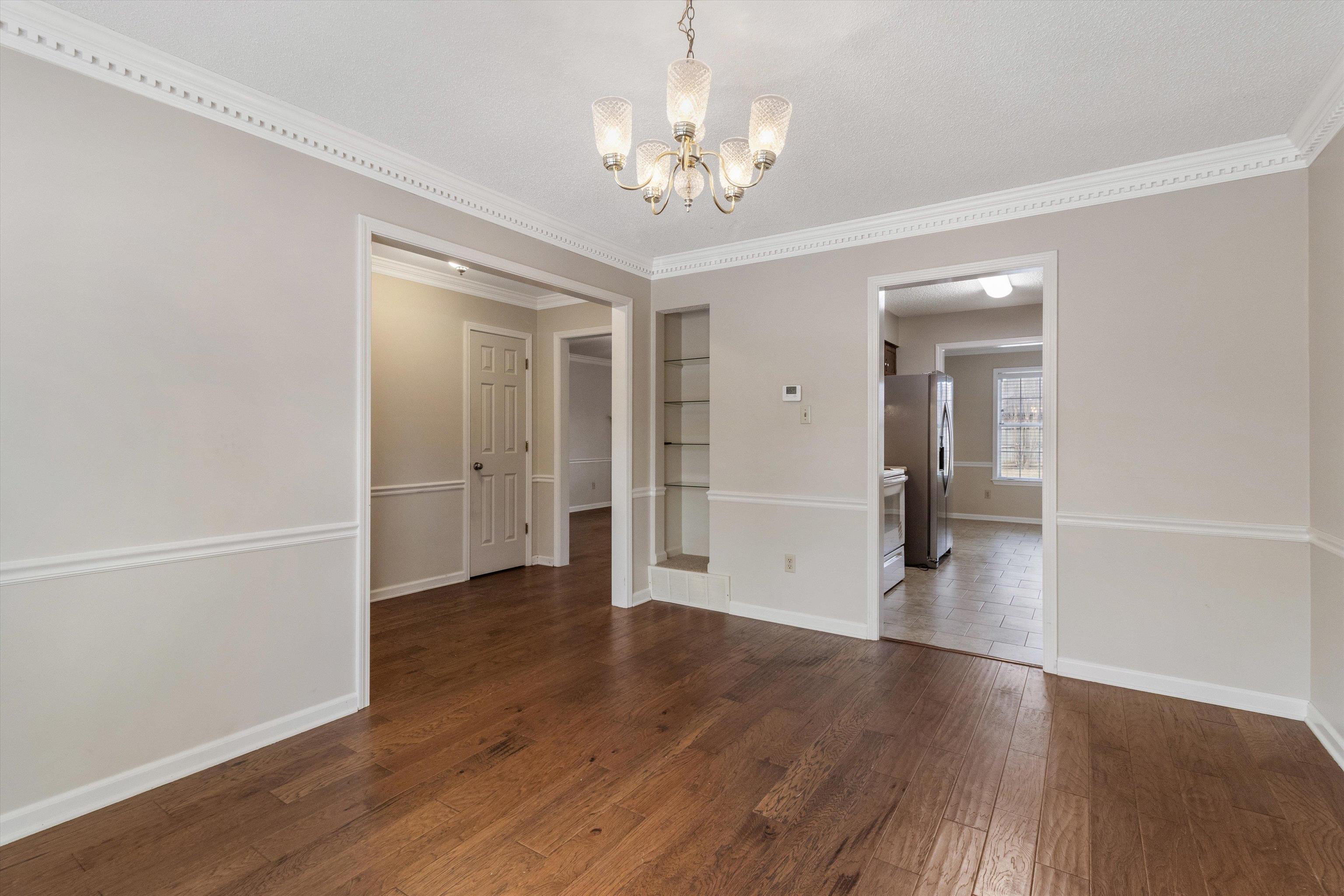 486 Harts Way Drive Collierville, TN 38017 - Photo 7 of 39 wooden floor in an empty room with a window