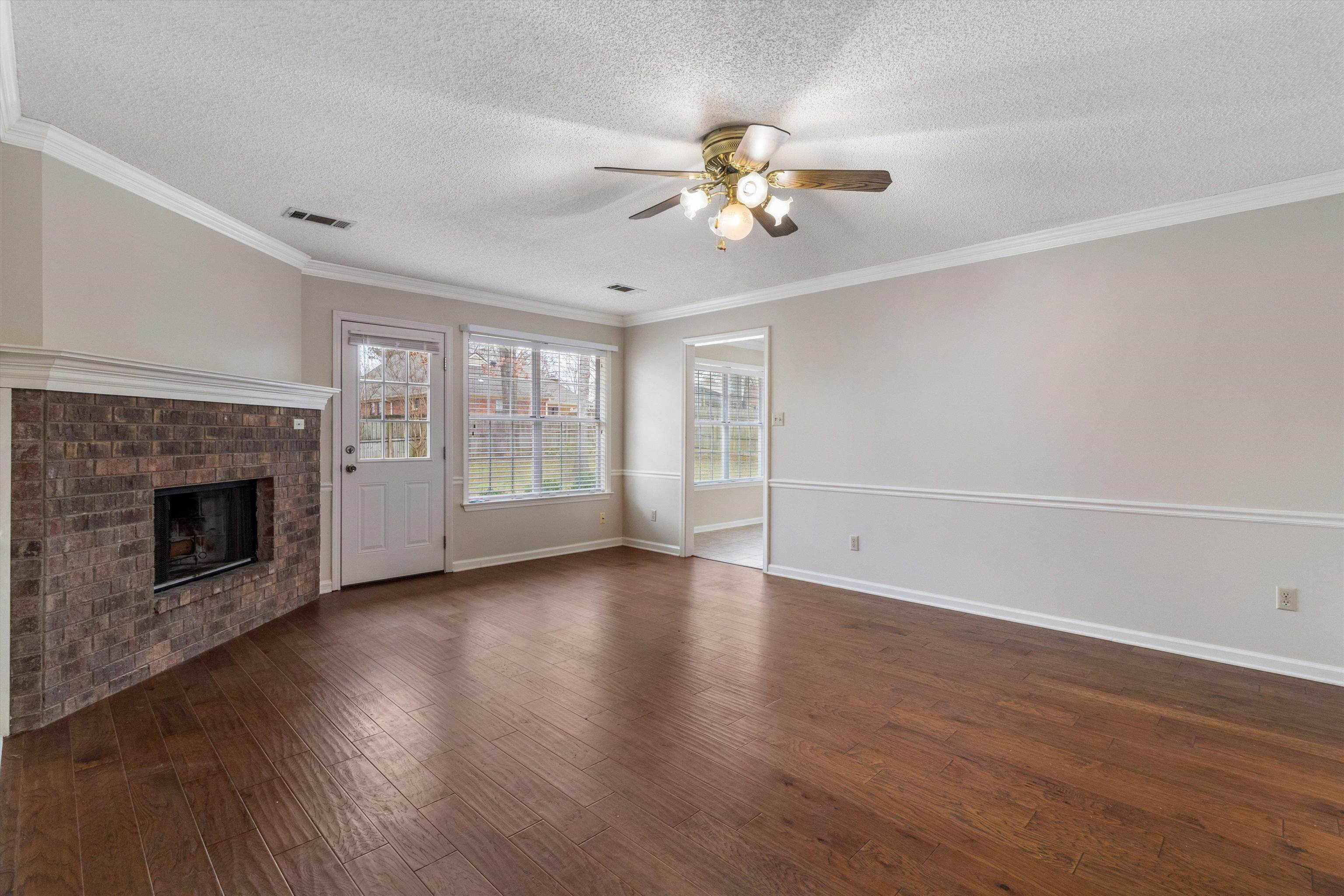 486 Harts Way Drive Collierville, TN 38017 - Photo 8 of 39 a view of an empty room with wooden floor and a fireplace