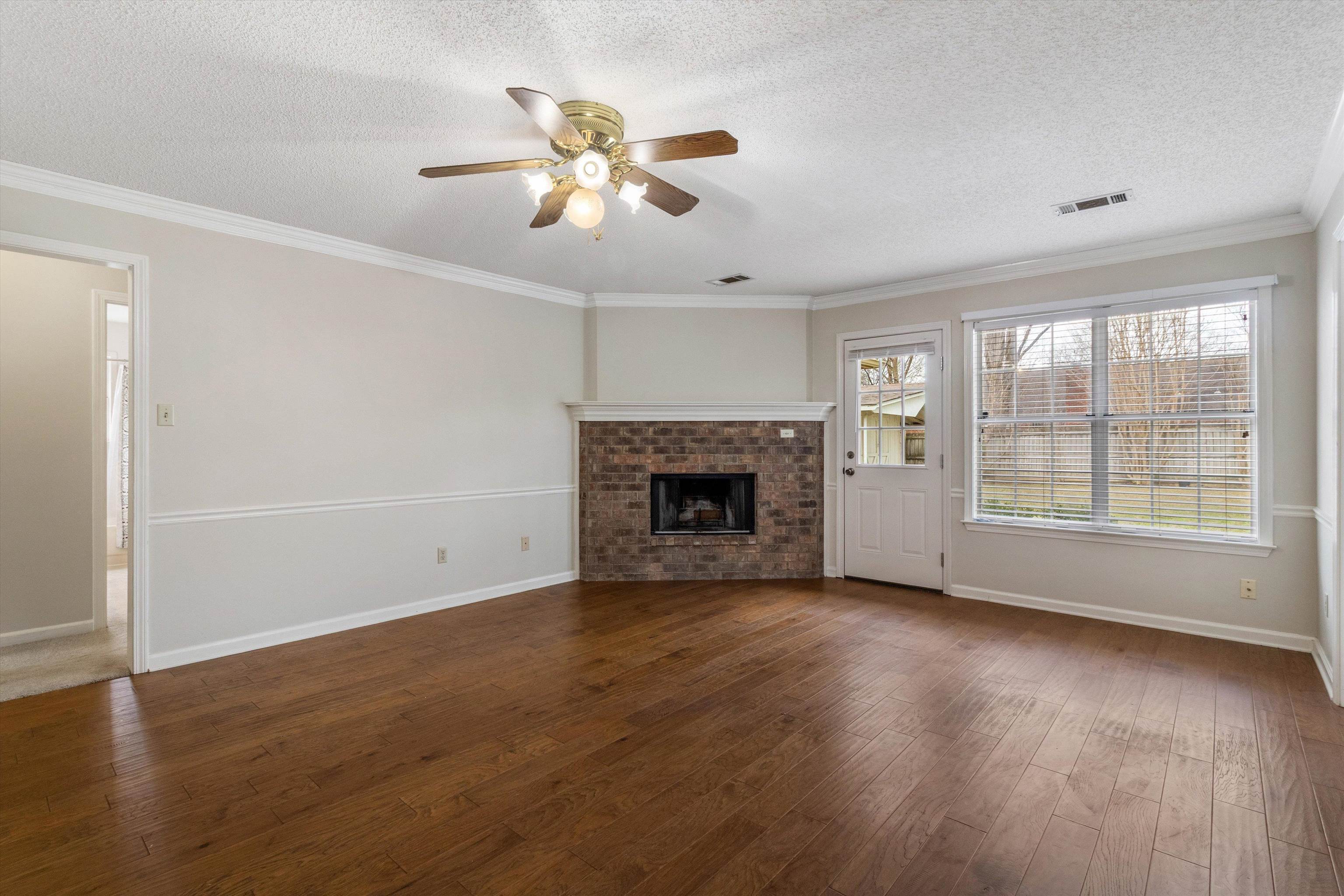 486 Harts Way Drive Collierville, TN 38017 - Photo 10 of 39 a view of an empty room with wooden floor and a window