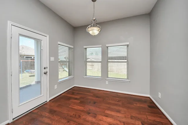 a living room with a bed furniture flat screen tv and window