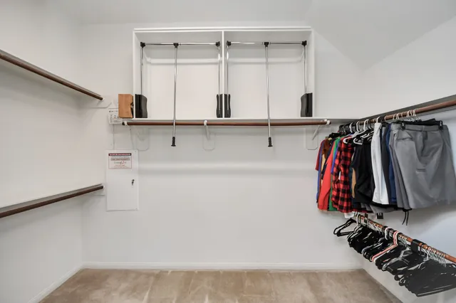 a spacious bedroom with a large bed and a large window