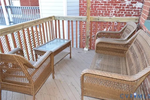 a living room with furniture flowerpot and wooden floor