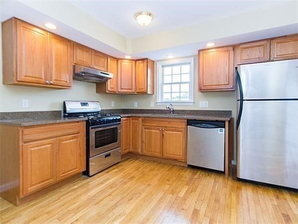 31-35 Juniper Street Boston, MA 02119 - Photo 2 of 14 a kitchen with a white cabinets and white appliances