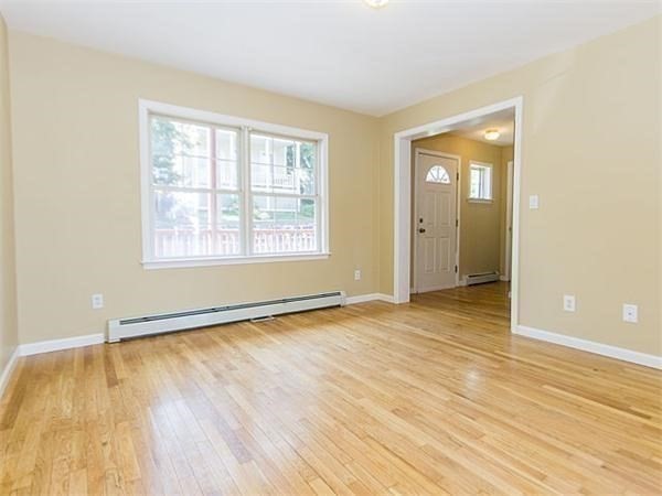 31-35 Juniper Street Boston, MA 02119 - Photo 3 of 14 an empty room with wooden floor and windows