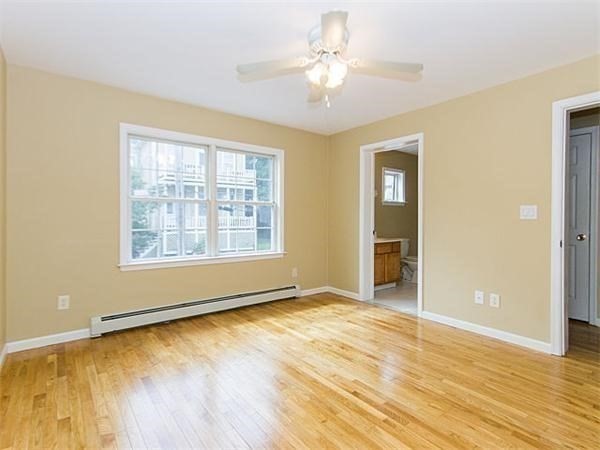 31-35 Juniper Street Boston, MA 02119 - Photo 5 of 14 a view of an empty room with wooden floor and a window