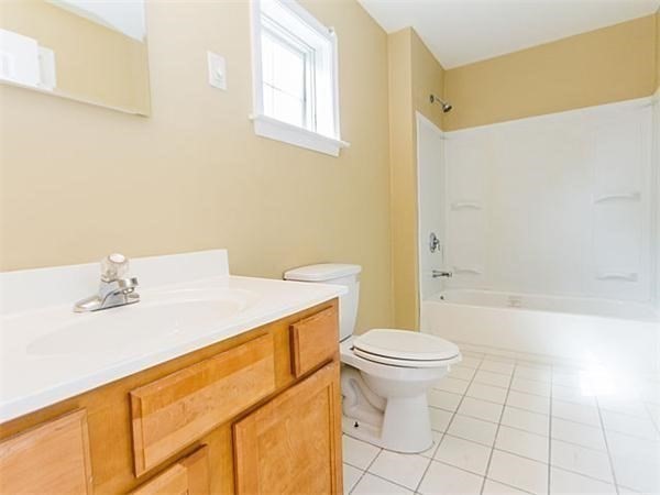 31-35 Juniper Street Boston, MA 02119 - Photo 6 of 14 a bathroom with a sink a toilet and a bathtub